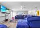 Cozy living room with a large blue sectional sofa and a mounted flat-screen television at 1233 Nelson Park Court, Poinciana, FL 34759