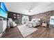 Stylish main bedroom featuring a king-sized bed, contemporary decor, and a large flat-screen television at 1233 Nelson Park Court, Poinciana, FL 34759