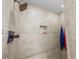 Elegant shower with tiled walls, a rainfall showerhead, and a built-in niche at 1233 Nelson Park Court, Poinciana, FL 34759