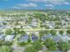 Aerial view of the neighborhood with many mature trees and landscaping throughout at 13505 Phoenix Dr, Orlando, FL 32828