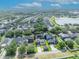 Wide aerial shot of the residential neighborhood highlighting well-maintained homes near a beautiful, serene lake at 13505 Phoenix Dr, Orlando, FL 32828
