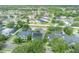 An overhead shot shows a single Gathering home in a suburban neighborhood with solar panels and well-manicured lawns at 13505 Phoenix Dr, Orlando, FL 32828