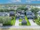 Beautiful aerial view of a home featuring a screened pool and backyard with lush greenery at 13505 Phoenix Dr, Orlando, FL 32828