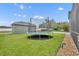 Spacious backyard featuring a trampoline on well-maintained grass at 13505 Phoenix Dr, Orlando, FL 32828