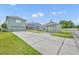 Backyard featuring the home's rear elevation, a screened pool, detached garage and green space at 13505 Phoenix Dr, Orlando, FL 32828
