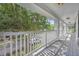 Balcony features a white railing and view of the street and mature trees at 13505 Phoenix Dr, Orlando, FL 32828