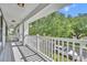 Spacious balcony with white railing overlooking the street and lush foliage at 13505 Phoenix Dr, Orlando, FL 32828