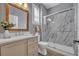 Bathroom featuring a wood-framed mirror, granite vanity top, and a frameless glass shower door at 13505 Phoenix Dr, Orlando, FL 32828