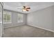 Bedroom with neutral carpet, a ceiling fan, and windows with white shutters at 13505 Phoenix Dr, Orlando, FL 32828