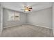Bedroom with neutral carpet, a ceiling fan, and a window with shutters at 13505 Phoenix Dr, Orlando, FL 32828