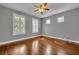 Spacious bedroom with hardwood floors, natural light, and a ceiling fan at 13505 Phoenix Dr, Orlando, FL 32828