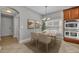 Bright dining area with a chandelier, neutral decor, and stainless steel double ovens at 13505 Phoenix Dr, Orlando, FL 32828