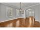 A bright dining room with hardwood floors, plantation shutters, and elegant lighting fixtures at 13505 Phoenix Dr, Orlando, FL 32828