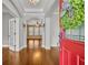 Inviting foyer with hardwood floors, archways, and a bright red front door adorned with a festive wreath at 13505 Phoenix Dr, Orlando, FL 32828
