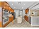 Spacious kitchen featuring stainless steel appliances, granite countertops, and abundant wood cabinetry at 13505 Phoenix Dr, Orlando, FL 32828
