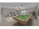 Entertainment room featuring a pool table, neutral carpet, and large window at 13505 Phoenix Dr, Orlando, FL 32828