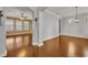 A bright, airy living room boasts gleaming hardwood floors, elegant archways, and neutral walls at 13505 Phoenix Dr, Orlando, FL 32828