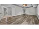 Spacious main bedroom featuring a ceiling fan, ensuite, and wood-look flooring at 13505 Phoenix Dr, Orlando, FL 32828