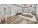 Spacious main bedroom featuring a ceiling fan, ensuite, and wood-look flooring at 13505 Phoenix Dr, Orlando, FL 32828