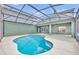 Lovely kidney-shaped pool with a screened enclosure, ideal for escaping the heat and enjoying outdoor living at 13505 Phoenix Dr, Orlando, FL 32828