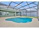 A pristine in-ground pool enclosed by a screen, offering a serene retreat for relaxation and recreation at 13505 Phoenix Dr, Orlando, FL 32828