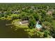 Aerial view of the community clubhouse, pool, and dock on a picturesque lake at 140 Margate Mews, Longwood, FL 32779