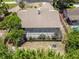 An aerial view of a backyard featuring a screen enclosed patio and lush landscaping at 140 Margate Mews, Longwood, FL 32779