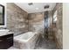 Nicely renovated bathroom with shower, soaking tub and mosaic tile at 140 Margate Mews, Longwood, FL 32779
