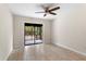 Bright bedroom featuring tile floors and a sliding glass door to the screened patio at 140 Margate Mews, Longwood, FL 32779