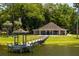 Community clubhouse featuring a wooden pier, offering a serene waterfront setting at 140 Margate Mews, Longwood, FL 32779