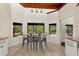 Bright dining area with tile floors, modern lighting, and views of the backyard patio at 140 Margate Mews, Longwood, FL 32779