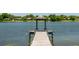 Long pier with gazebo on calm lake surrounded by trees at 140 Margate Mews, Longwood, FL 32779