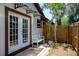 Charming exterior with a white bench and a wooden fence at 140 Margate Mews, Longwood, FL 32779