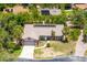 Aerial view of a charming one-story home with a basketball hoop and well-maintained landscaping at 140 Margate Mews, Longwood, FL 32779