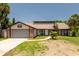 Charming single-Gathering home featuring a two-car garage and well-maintained front yard in a sunny neighborhood at 140 Margate Mews, Longwood, FL 32779