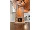 Living room showcasing a fireplace, hardwood floors, high ceilings, and kitchen view at 140 Margate Mews, Longwood, FL 32779