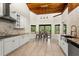 Modern kitchen with tile floors, stainless steel appliances, white cabinets, and granite countertops at 140 Margate Mews, Longwood, FL 32779
