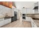 Modern kitchen with stainless steel appliances, white cabinets, and granite countertops at 140 Margate Mews, Longwood, FL 32779