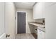Laundry room features granite countertop and plenty of storage space at 140 Margate Mews, Longwood, FL 32779