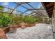Enclosed patio featuring lush green plants and outdoor seating at 140 Margate Mews, Longwood, FL 32779