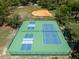 Aerial view of tennis and pickleball courts surrounded by trees in a Gathering-friendly community at 140 Margate Mews, Longwood, FL 32779