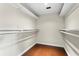 Empty walk-in closet with shelving and wood flooring at 140 Margate Mews, Longwood, FL 32779