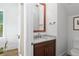 Half bath with wood vanity, granite top, and framed mirror at 1429 Indiana Ave, Winter Park, FL 32789