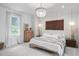 This bedroom features a decorative light fixture, an accent wall hanging, and a window with natural light at 1429 Indiana Ave, Winter Park, FL 32789