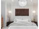 A bedroom featuring a hanging chandelier, decorative light fixtures, and an accent wall hanging at 1429 Indiana Ave, Winter Park, FL 32789