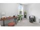 A bright bedroom features a functional desk space, stylish chair and plant for a modern and peaceful feel at 1429 Indiana Ave, Winter Park, FL 32789
