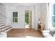 Light-filled foyer with hardwood floors, open staircase, and a glimpse of the outdoors at 1429 Indiana Ave, Winter Park, FL 32789