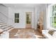 Inviting foyer showcases hardwood floors, a staircase, and natural light creating an airy and welcoming atmosphere at 1429 Indiana Ave, Winter Park, FL 32789