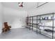 Organized garage with shelving units, storage containers, and a clean, epoxy floor at 1429 Indiana Ave, Winter Park, FL 32789