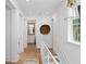 Bright hallway with hardwood floors and view to bathroom with floating vanity at 1429 Indiana Ave, Winter Park, FL 32789